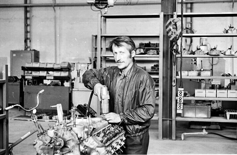 a historic picture of a man working on an engine in Kuusalu Factory
